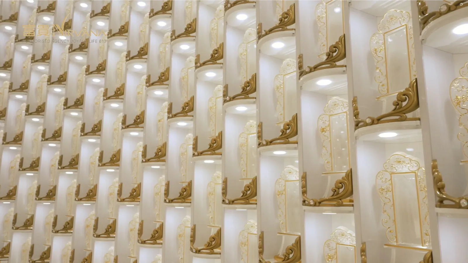 Rows of pale memorial tablets with gilded edges, seen at an angle